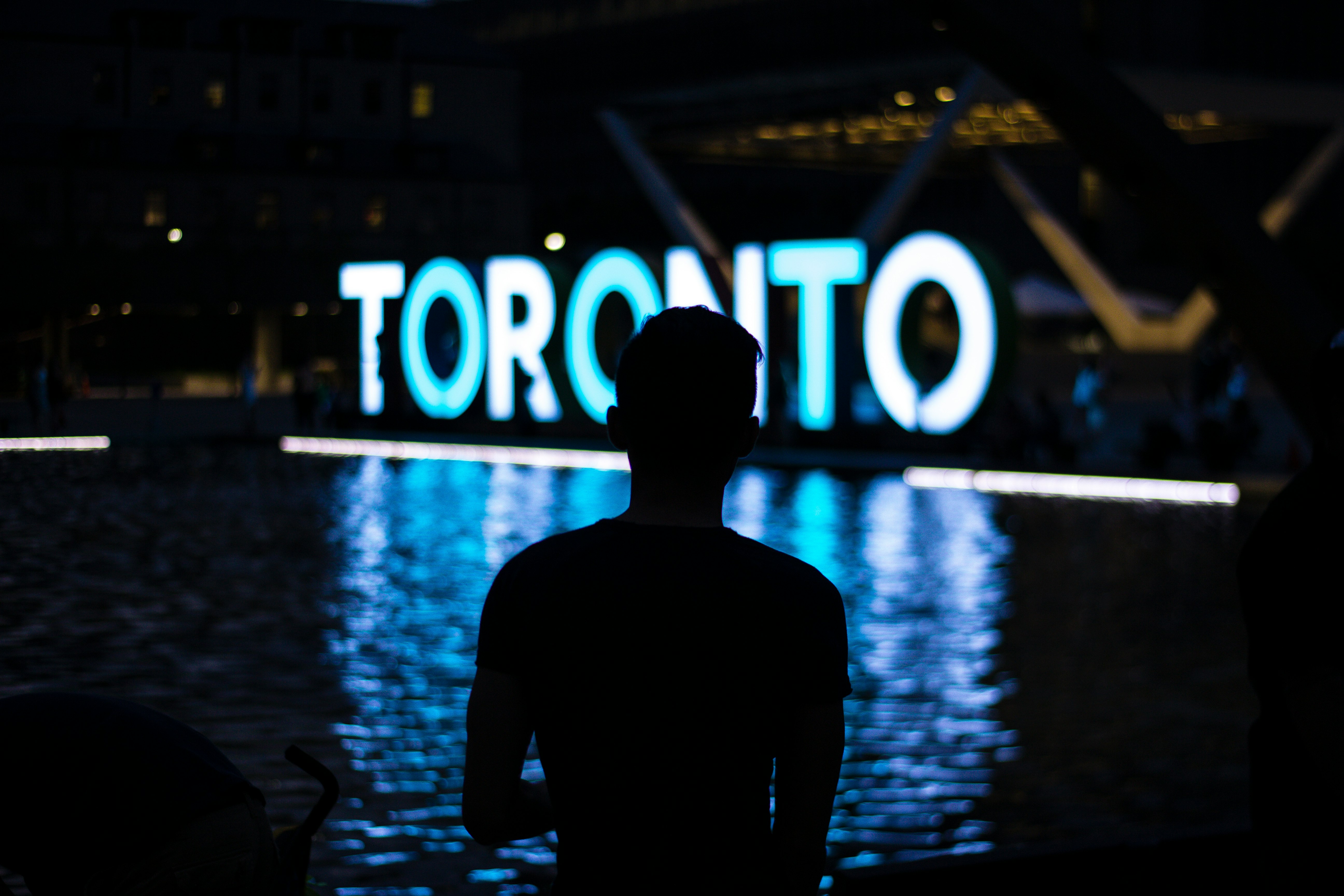 man facing Toronto LED signage